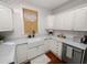 Kitchen featuring subway tile backsplash, a white farmhouse sink, and white cabinets at 805 Johnson Ave, Lakeland, FL 33801