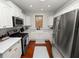 A stylish kitchen with subway tile, white cabinets, and stainless steel appliances at 805 Johnson Ave, Lakeland, FL 33801