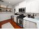 Modern kitchen with white cabinets, granite countertops, and stainless steel appliances at 805 Johnson Ave, Lakeland, FL 33801