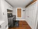 Laundry room with washer, dryer, white cabinets, and wood floors at 805 Johnson Ave, Lakeland, FL 33801