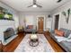 Open living room featuring hardwood floors, comfortable seating, and a decorative fireplace at 805 Johnson Ave, Lakeland, FL 33801
