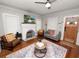 Cozy living room with hardwood floors, a decorative fireplace, and comfortable seating at 805 Johnson Ave, Lakeland, FL 33801