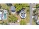 Aerial view of a charming home with large trees, a pool, and a detached garage at 822 W Patterson St, Lakeland, FL 33803
