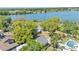 Aerial view of a charming home with mature trees and a large lake in the background at 822 W Patterson St, Lakeland, FL 33803