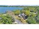 A beautiful home is nestled amongst mature trees with a lake in the background at 822 W Patterson St, Lakeland, FL 33803