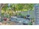 An outdoor patio area features a grill, concrete bench and lush garden in this relaxing backyard at 822 W Patterson St, Lakeland, FL 33803