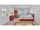 Bright bedroom boasts hardwood floors, a window with blinds and elegant vintage decor at 822 W Patterson St, Lakeland, FL 33803