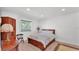 Bright bedroom with hardwood floors, a window with blinds and furniture at 822 W Patterson St, Lakeland, FL 33803