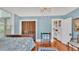 This bedroom features hardwood floors, a blue color scheme, a closet, and vintage furniture at 822 W Patterson St, Lakeland, FL 33803