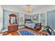 This bedroom features hardwood floors, a blue color scheme, chandelier, and vintage furniture at 822 W Patterson St, Lakeland, FL 33803