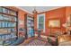 Cozy den with bookshelves, armchair, and warm lighting at 822 W Patterson St, Lakeland, FL 33803