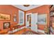 Den with hardwood floors, warm lighting, and elegant artwork at 822 W Patterson St, Lakeland, FL 33803