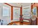 Inviting foyer with a decorative chair, wood floors, and warm ambiance at 822 W Patterson St, Lakeland, FL 33803