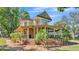 Two-story home with a large, covered wrap-around porch and brick stairs leading to the front door at 822 W Patterson St, Lakeland, FL 33803