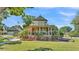 Charming two-story home with wraparound porch, mature landscaping, and a detached garage at 822 W Patterson St, Lakeland, FL 33803