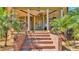 Inviting home front entrance with brick stairs and lush tropical landscaping at 822 W Patterson St, Lakeland, FL 33803