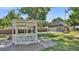 Well-manicured backyard featuring a gazebo, detached garage and mature landscaping at 822 W Patterson St, Lakeland, FL 33803