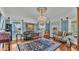 Elegant living room with large windows, hardwood floors, and a chandelier at 822 W Patterson St, Lakeland, FL 33803