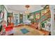 This living room features a white piano, green walls, hardwood floors, and a staircase at 822 W Patterson St, Lakeland, FL 33803
