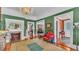 This living room features green walls, hardwood floors, a fireplace, and vintage furniture at 822 W Patterson St, Lakeland, FL 33803