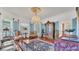 Bright living room with hardwood floors, large windows, and ornate chandelier at 822 W Patterson St, Lakeland, FL 33803