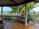 Relax on the covered porch with views of the lake, lush greenery, and blue skies at 822 W Patterson St, Lakeland, FL 33803