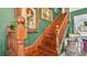 This staircase features wooden railings, green walls, vintage art, and hardwood floors at 822 W Patterson St, Lakeland, FL 33803
