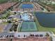 An aerial view of the community pool, lake, basketball court, and tennis courts at 8931 Sugar Palm Rd, Kissimmee, FL 34747