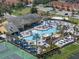 Aerial view of the community pool with an oversized swimming pool, palm trees, and plenty of lounge chairs at 8931 Sugar Palm Rd, Kissimmee, FL 34747