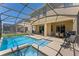 Inviting screened-in pool, patio, and jacuzzi; perfect for outdoor relaxation and entertaining at 8931 Sugar Palm Rd, Kissimmee, FL 34747