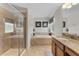 Well-lit bathroom with tile flooring, a shower, soaking tub, and a vanity with granite countertop at 8931 Sugar Palm Rd, Kissimmee, FL 34747