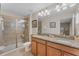 Bathroom features granite countertops, double sinks, tile floors, and a glass shower at 8931 Sugar Palm Rd, Kissimmee, FL 34747