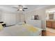 This bedroom has wood floors, a ceiling fan, and an ensuite bathroom with wood cabinets at 8931 Sugar Palm Rd, Kissimmee, FL 34747