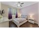 Bedroom with a window, ceiling fan, wood floors and light purple walls at 8931 Sugar Palm Rd, Kissimmee, FL 34747