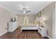 Bright bedroom features wood floors, ceiling fan, white furniture and a window with lots of natural light at 8931 Sugar Palm Rd, Kissimmee, FL 34747