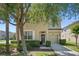 Charming two-story home features a neutral facade, well-manicured landscaping, and a cozy front porch at 8931 Sugar Palm Rd, Kissimmee, FL 34747