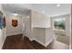Bright hallway with wood floors, white trim, and a window with a view of trees at 8931 Sugar Palm Rd, Kissimmee, FL 34747