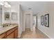 Hallway leading from bathroom featuring tile flooring and decor that enhances the home's appeal at 8931 Sugar Palm Rd, Kissimmee, FL 34747