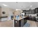 Kitchen offers an island with seating, seamlessly connecting to dining and living spaces for easy entertaining at 8931 Sugar Palm Rd, Kissimmee, FL 34747