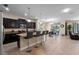 Open-concept kitchen with island seating flows into a dining area, creating an ideal space for entertaining at 8931 Sugar Palm Rd, Kissimmee, FL 34747