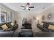 Spacious living room featuring leather sofas, ceiling fan, and sliding glass doors for optimal light at 8931 Sugar Palm Rd, Kissimmee, FL 34747