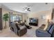 Cozy living room with comfortable seating, a ceiling fan, and sliding doors that lead to the outdoor space at 8931 Sugar Palm Rd, Kissimmee, FL 34747