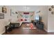 Comfortable entertainment area with themed decor, white sofa, and wood-look flooring at 8931 Sugar Palm Rd, Kissimmee, FL 34747