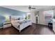 Relaxing primary suite with a blue accent wall, fan, and white furniture, creating a peaceful retreat at 8931 Sugar Palm Rd, Kissimmee, FL 34747