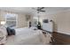 Primary bedroom featuring wood-look floors, fan, butterfly wall art, and natural light at 8931 Sugar Palm Rd, Kissimmee, FL 34747