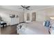 Comfortable primary suite with light-colored walls, wood-look floors, and access to ensuite bathroom at 8931 Sugar Palm Rd, Kissimmee, FL 34747