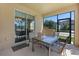 Covered patio with outdoor dining set, view of landscaped yard and sliding glass doors at 8931 Sugar Palm Rd, Kissimmee, FL 34747