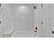 A well lit bathroom with a tub, shower, and a built in bench on the side at 919 S Missouri Ave, Lakeland, FL 33803