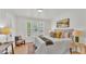 Cozy bedroom featuring a comfortable bed, neutral decor, and plenty of natural light at 919 S Missouri Ave, Lakeland, FL 33803