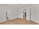 Bright bedroom showcasing hardwood floors, multiple doors, and lots of natural light at 919 S Missouri Ave, Lakeland, FL 33803